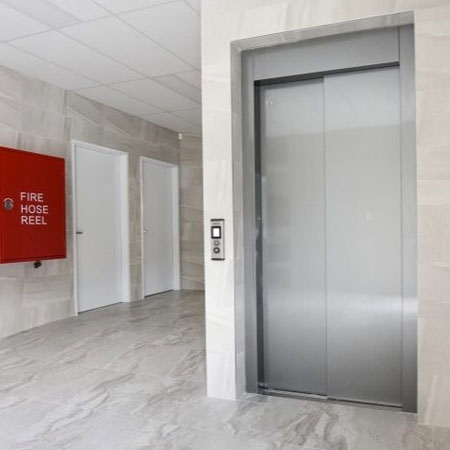 Commercial Stretcher lift with automatic sliding cabin and landing doors, 1000kg load capacity.